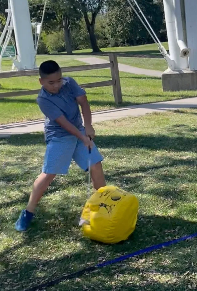 young golfer practicing his swing